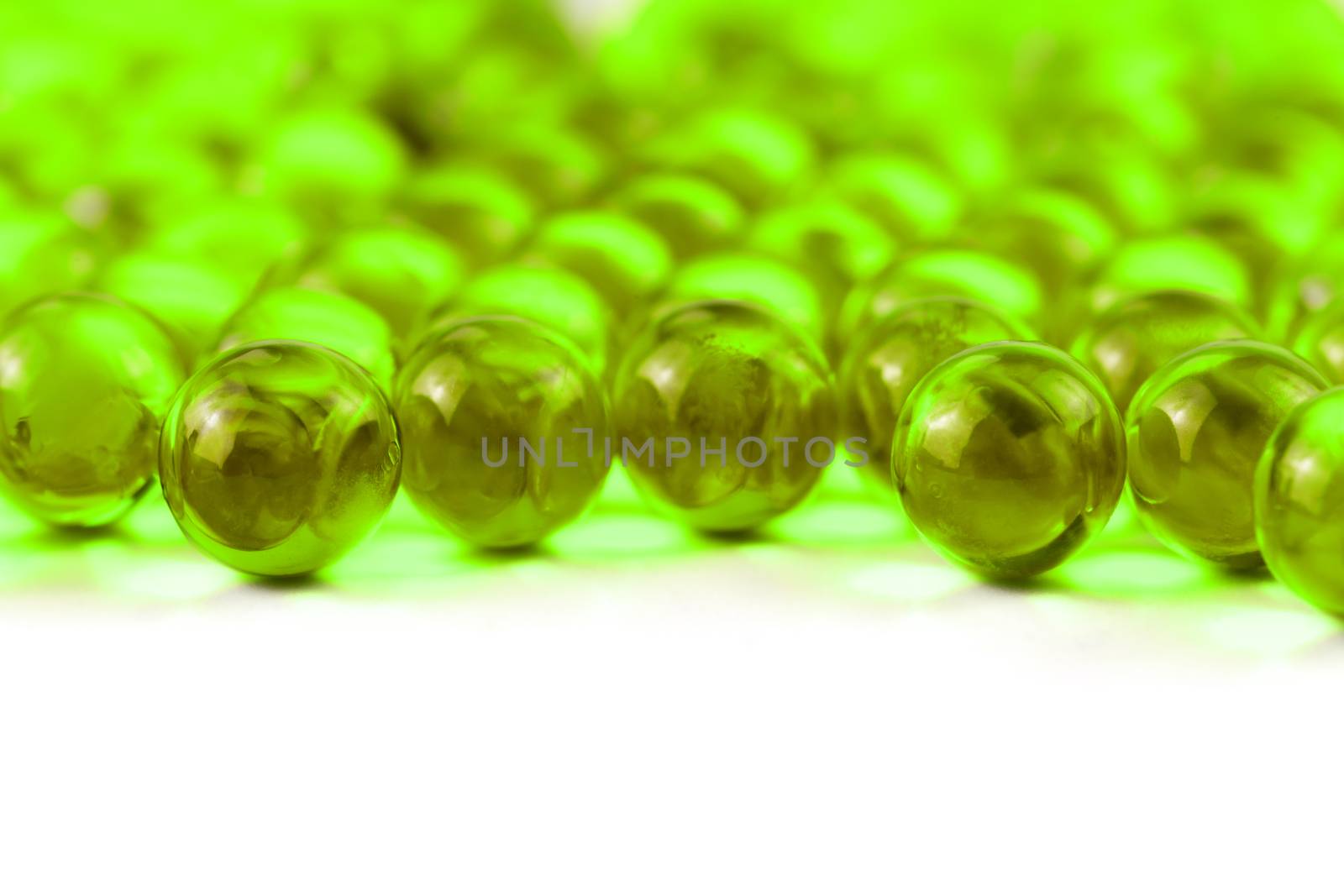 proton purple spherical ball capsules with selective focus isolated on white background.
