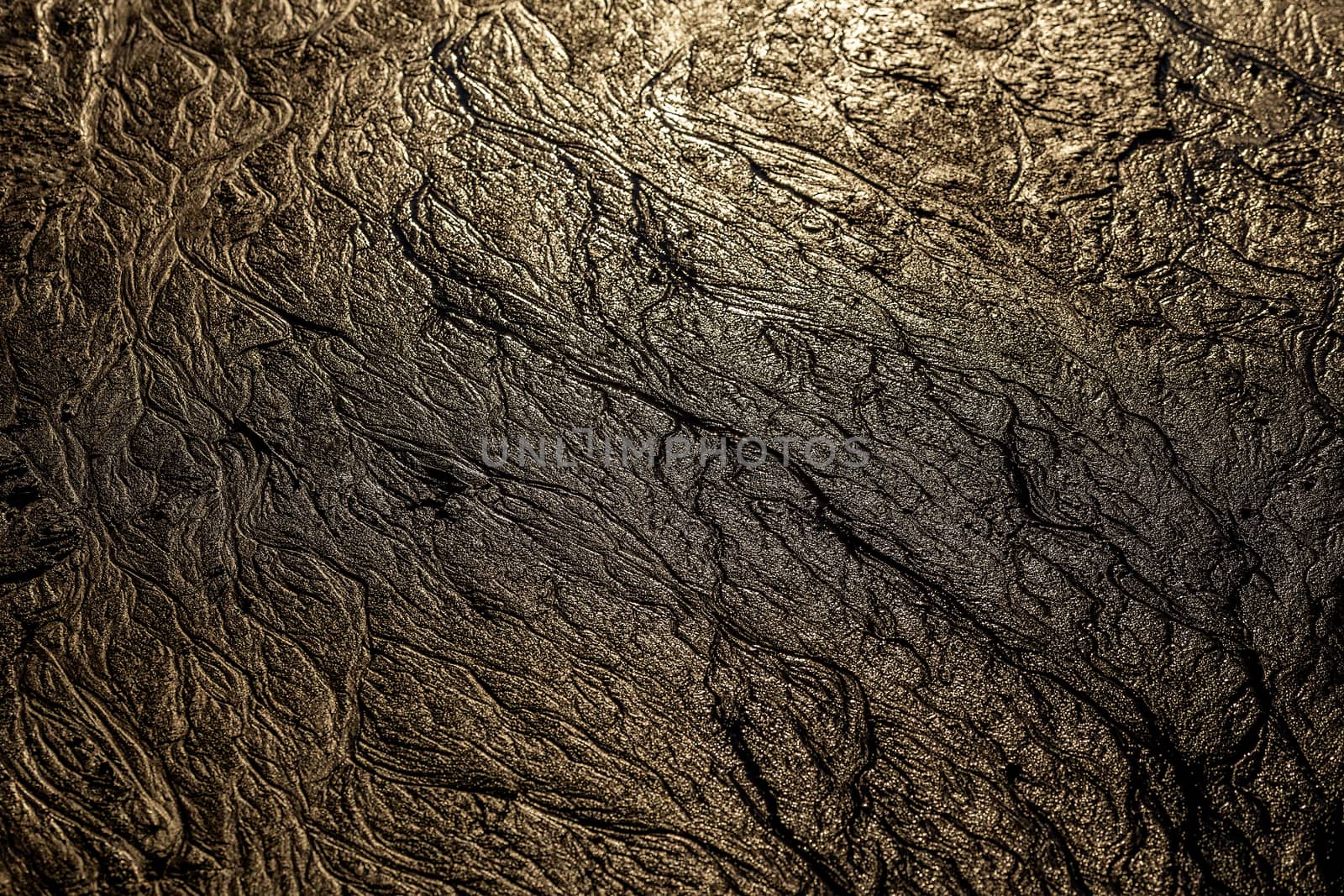 abstract mud background with water washout trails and selective focus.