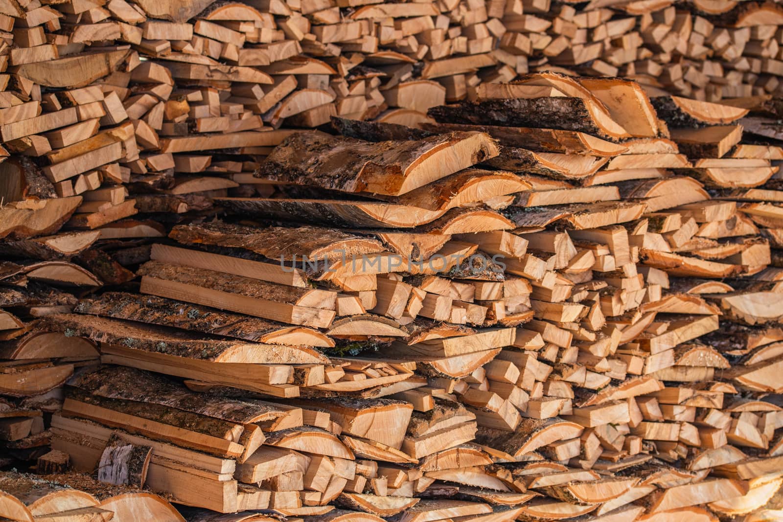 closeup background of firewood lumber leftovers stack with selective focus.