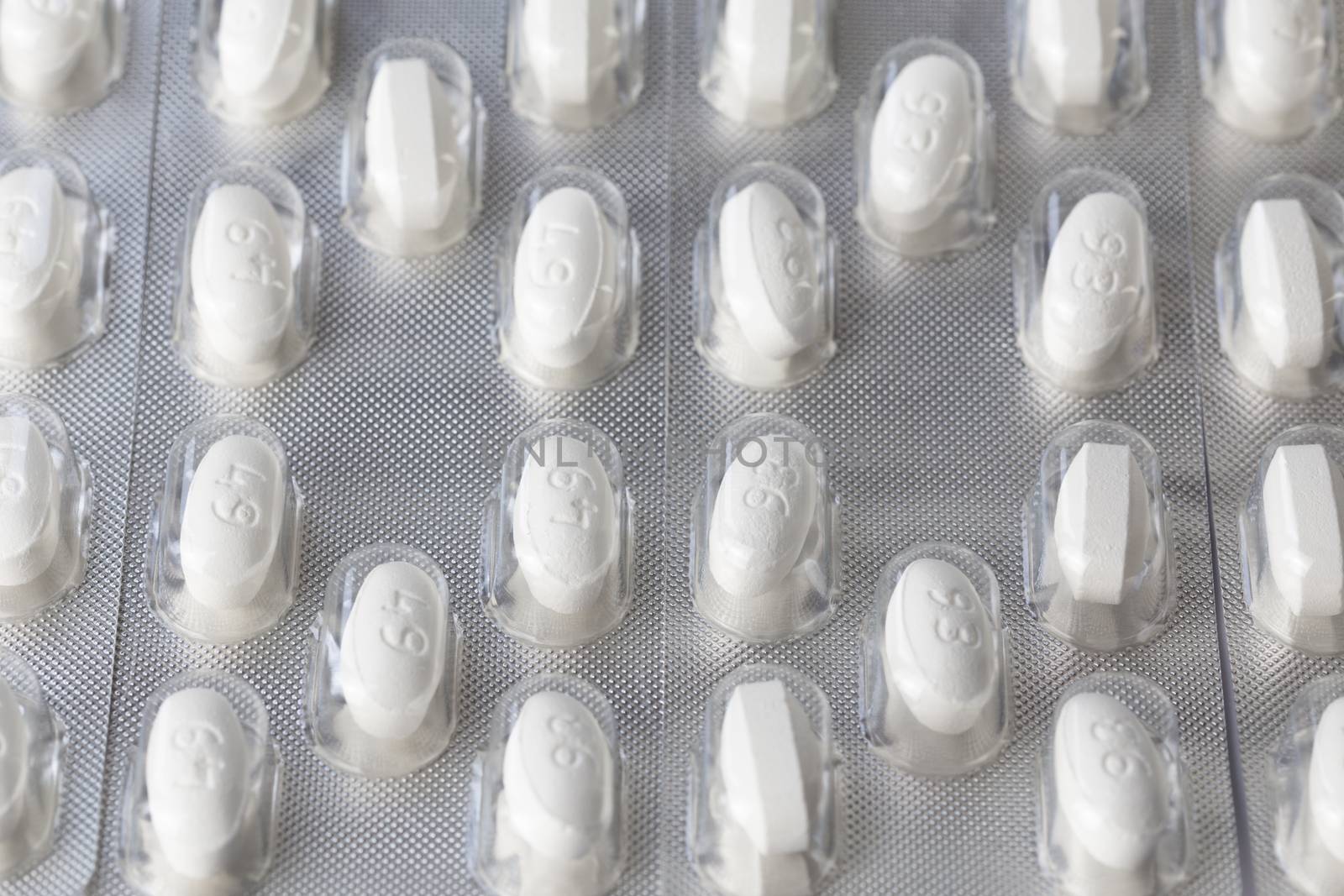 white tablets in blister closeup with selective focus.