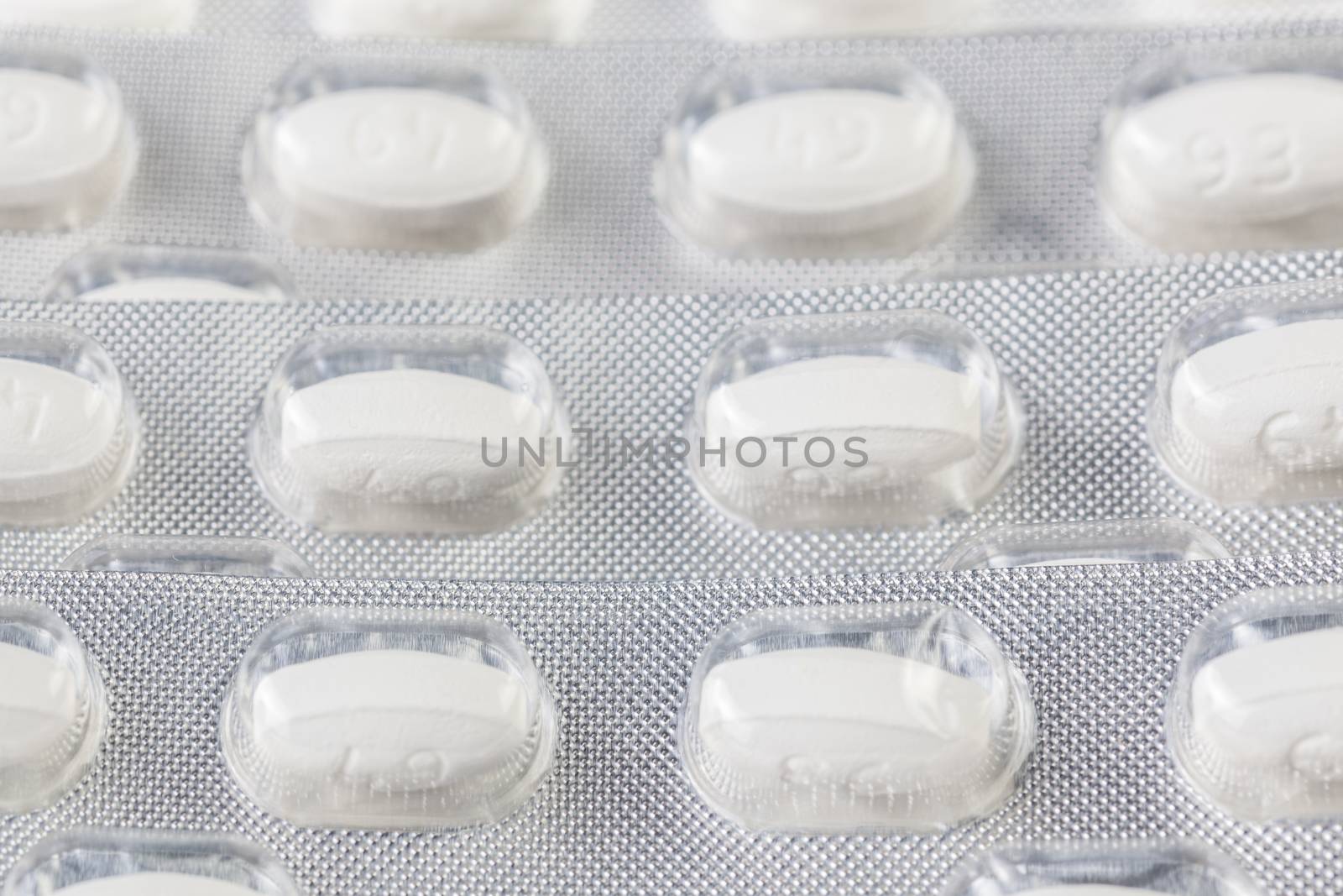 white tablets in blister closeup with selective focus.