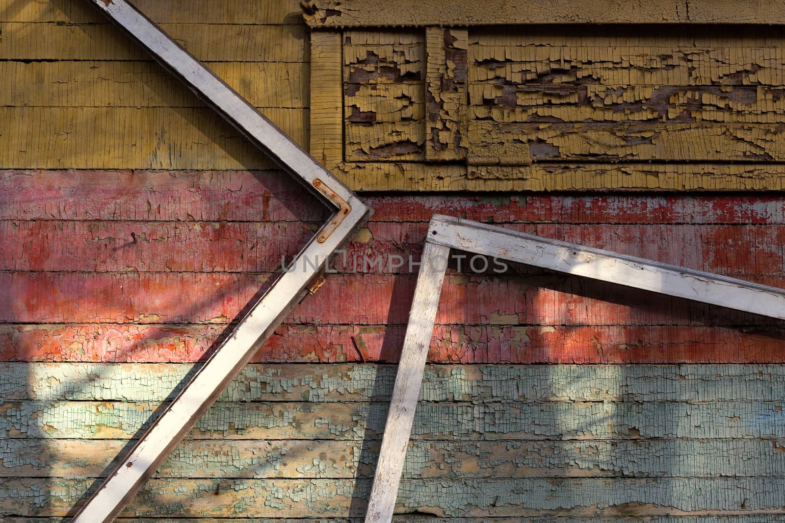 Abstract composition with a frames on old wooden wall with weathered peeling paint