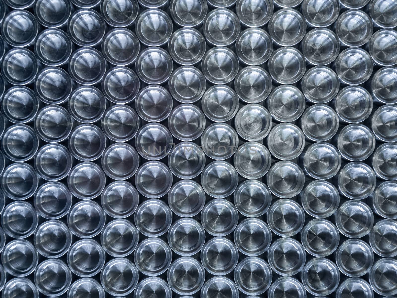 Shiny metal parts after cnc turning, on flat surface top-down flat lay background.