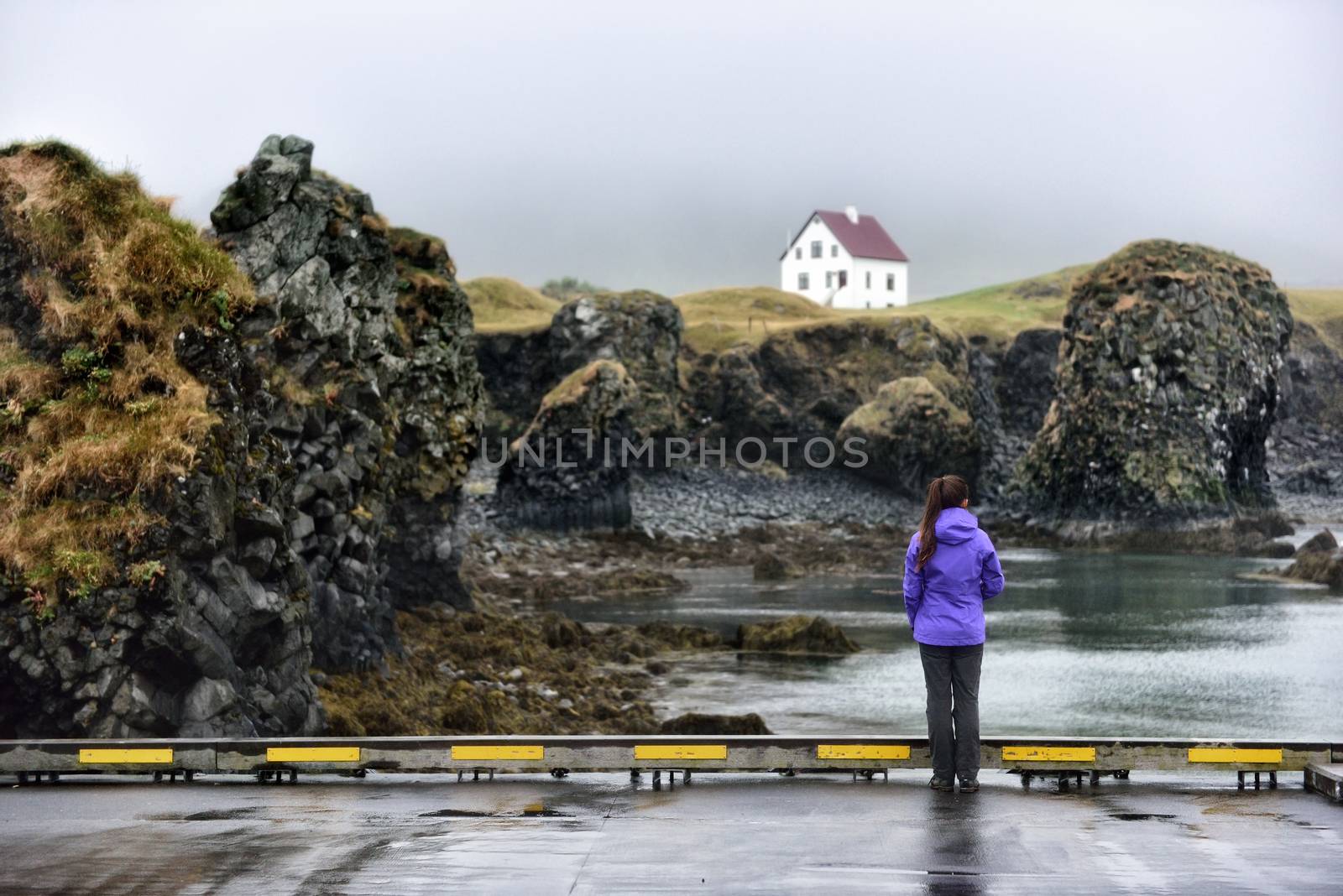 Iceland nature landscape on Arnarstapi Snaefellsnes. Travel photo of woman tourist looking at view of dramatic coast and ocean on West Iceland. From Arnarstapi harbour, Iceland by Maridav
