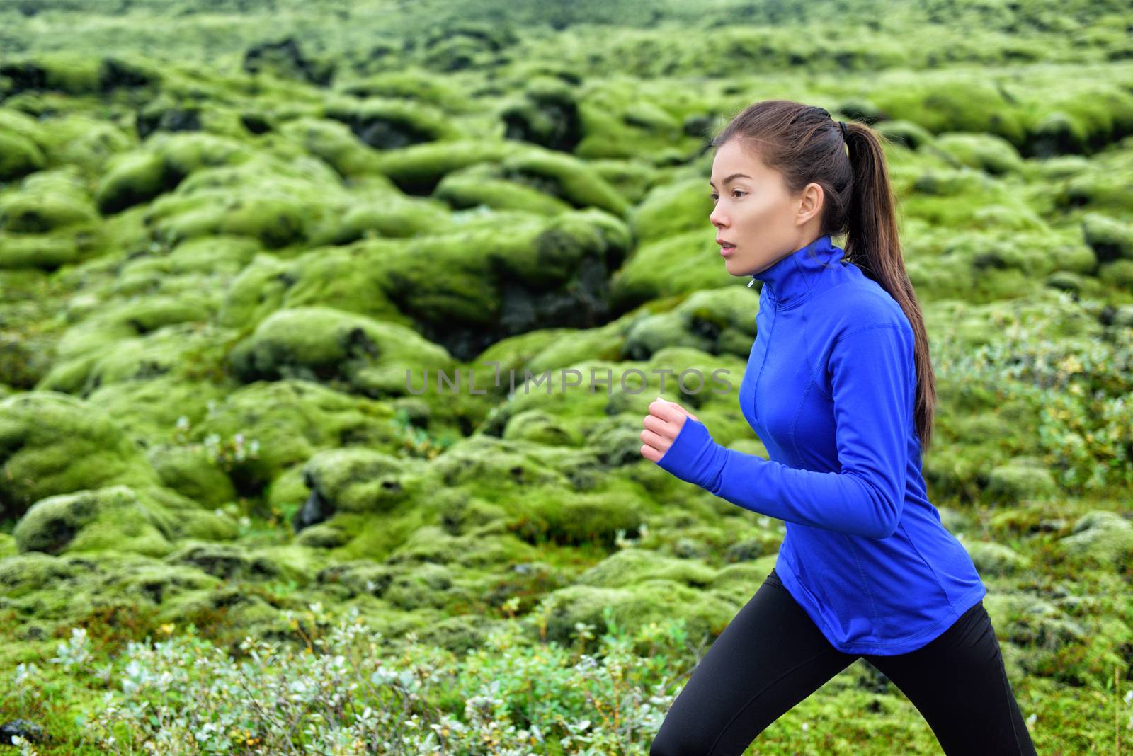 Woman runner training running outdoors. Fitness woman jogging outdoor. Morning running concept. Fit female on run by Maridav