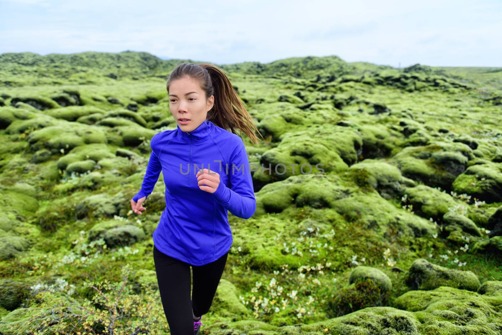 Athlete trail runner - running woman exercising. Fit female sport fitness model training jogging outdoors living healthy lifestyle in beautiful nature, Iceland.