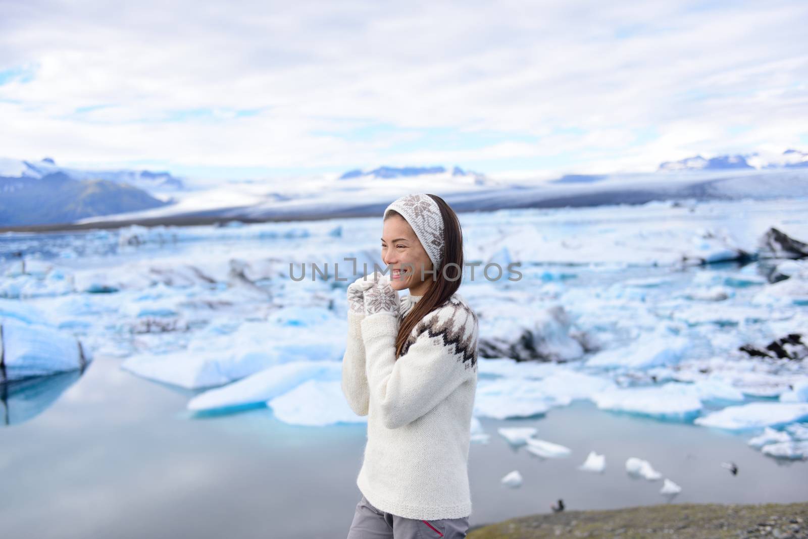 Iceland travel tourist enjoying nature landscape Jokulsarlon glacial lagoon on Iceland. Portrait of Woman standing outdoors by tourist destination landmark attraction. Vatnajokull National Park.