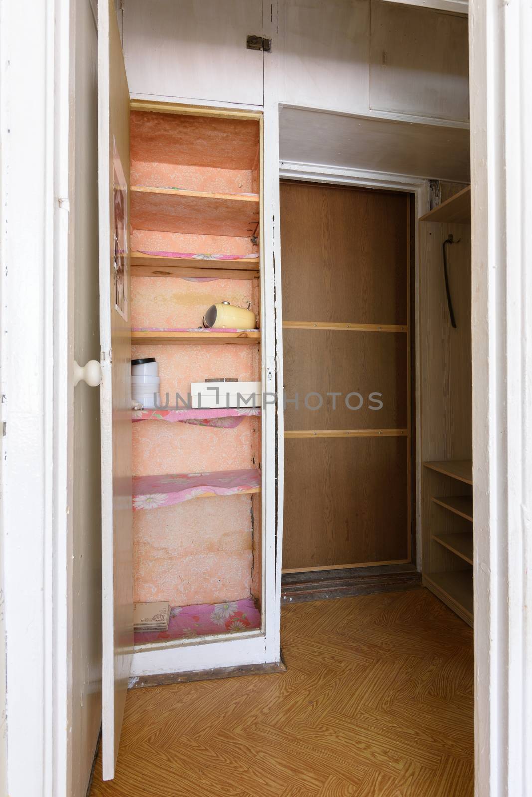 Old wardrobe in the interior of an apartment hallway with an outdated poor interior