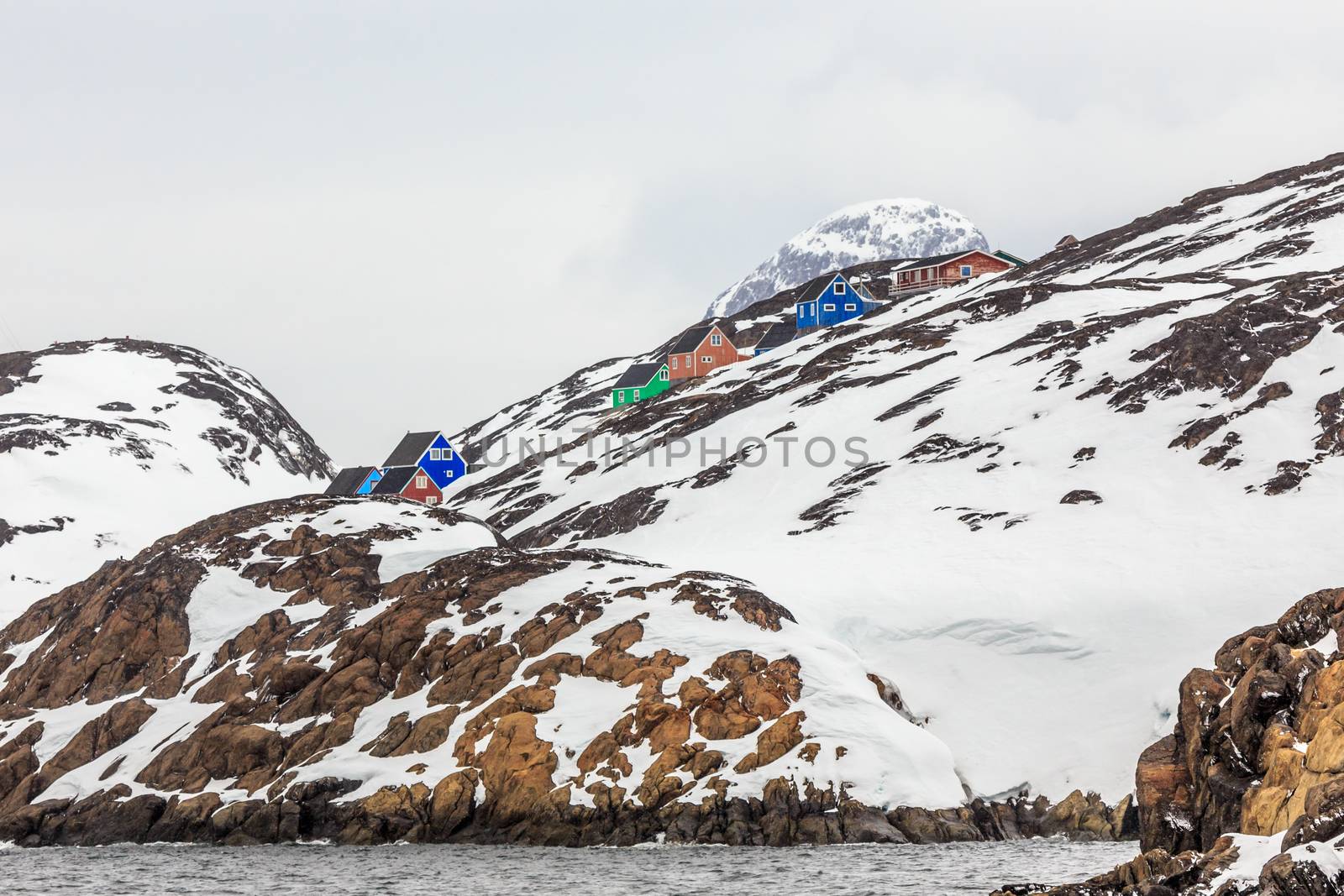 Inuit houses hidden among the rocks at the rocky fjord  in the middle of nowhere, Kangamiut, Greenland