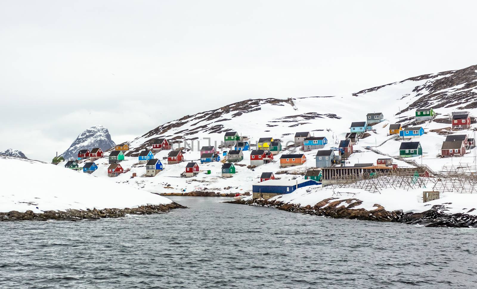 Colorful arctic fishing village houses at the rocky fjord  in the middle of nowhere, Kangamiut, Greenland