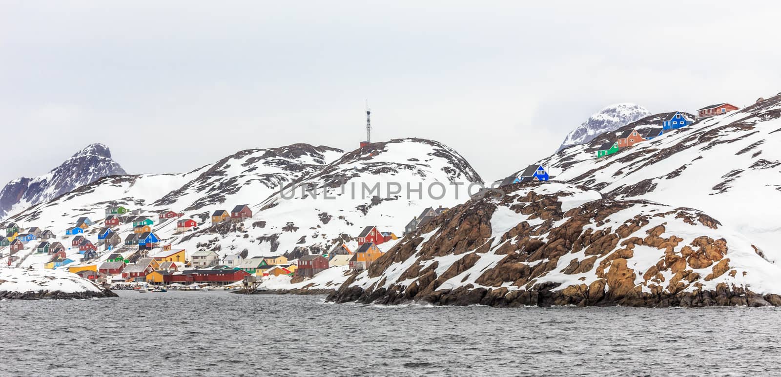 Colorful arctic village houses at the rocky fjord  in the middle by ambeon