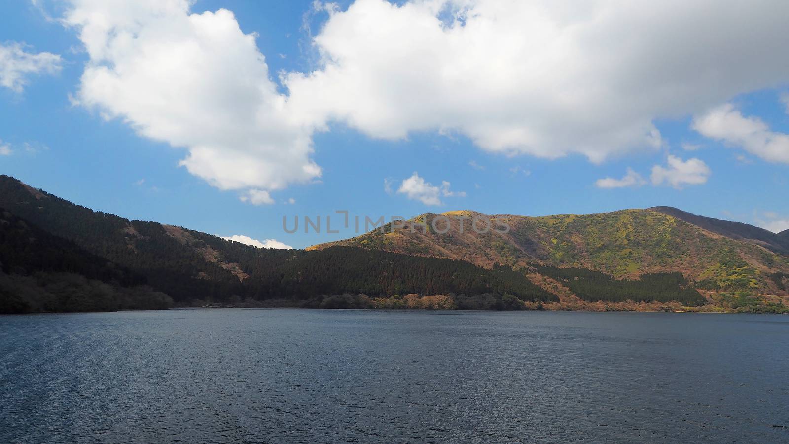 Hill and lake and clear blue sky and white clouds at five lakes near Kawaguchiko Tokyo Japan in winter season.
