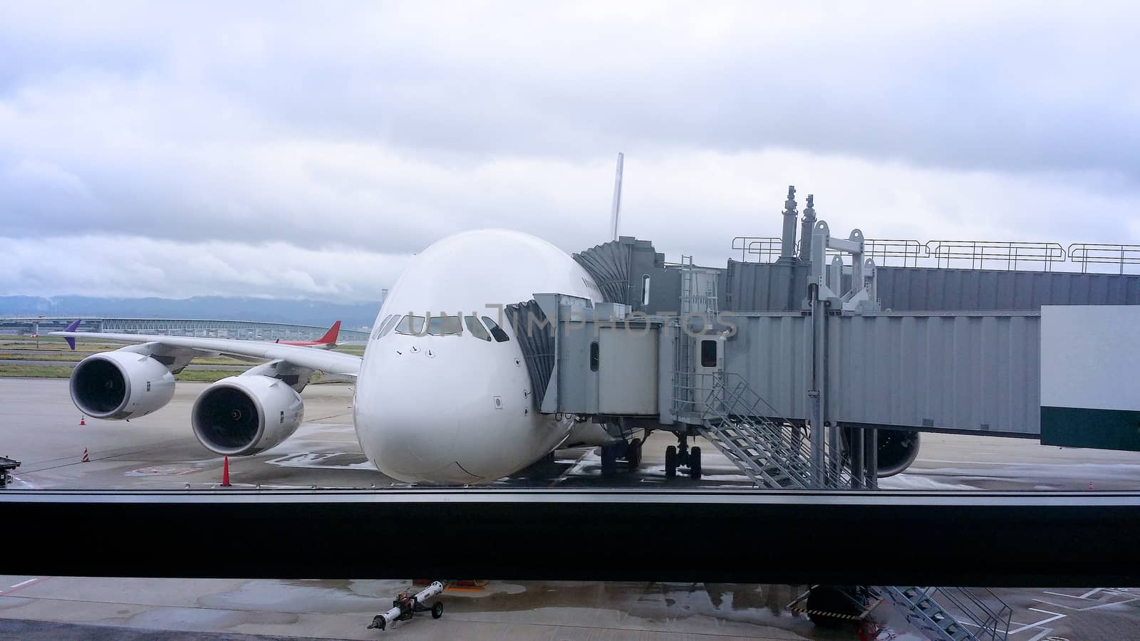 Modern jet bridge connection and airplane and outdoor.