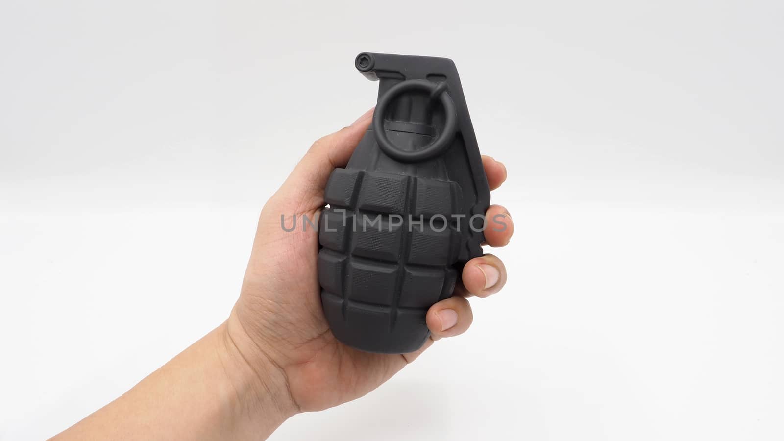 Man hand and military bomb plastic model toy and white background.