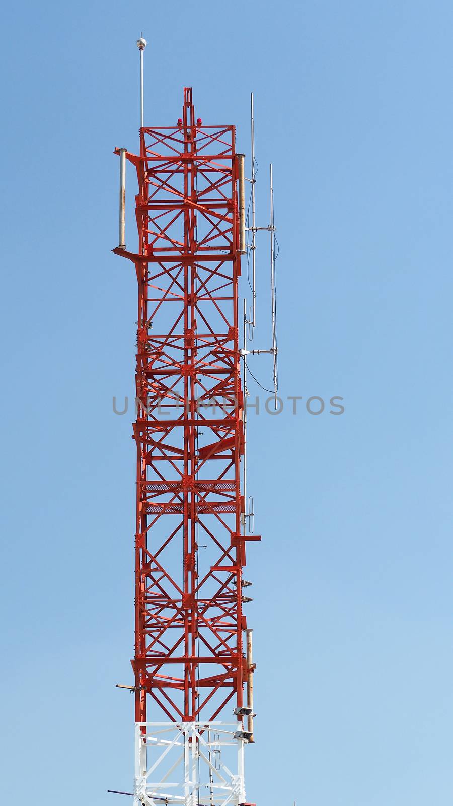 Telecommunication tower closeup with red and white color.