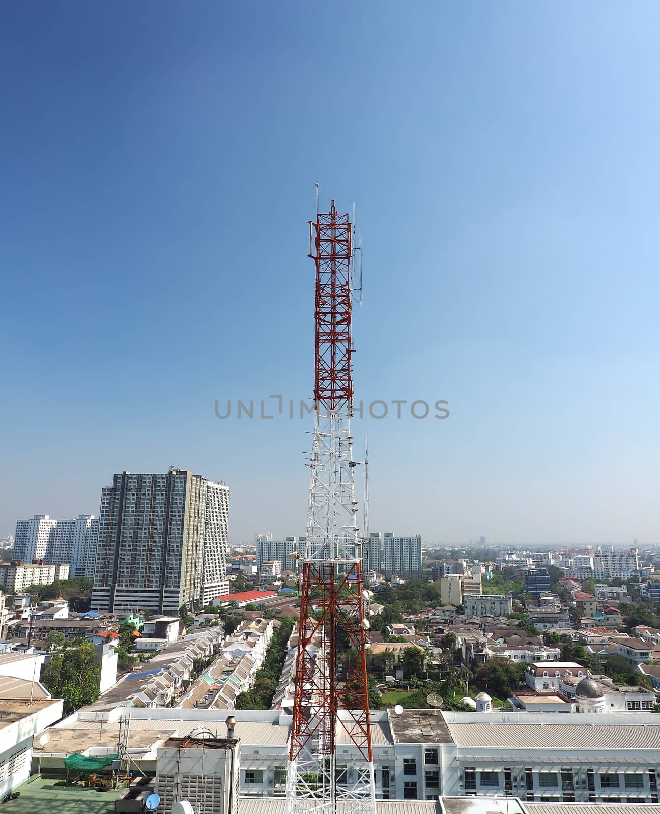 Telecommunication tower red and white color and blue sky.