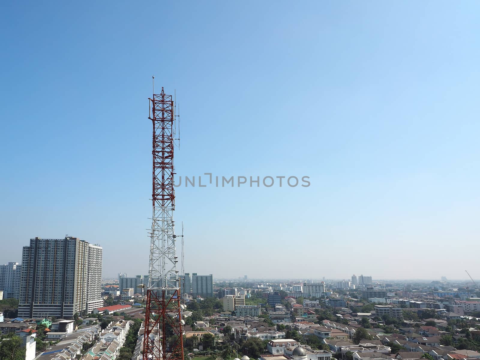 Telecommunication tower red and white color and blue sky.