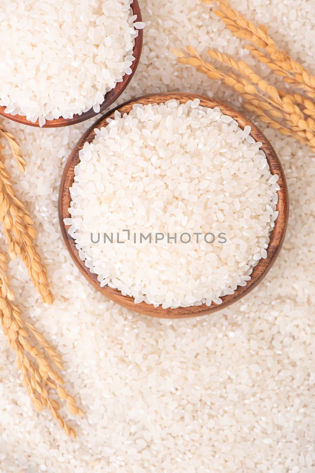 Raw rice in a bowl and full frame in the white background table, top view overhead shot, close up