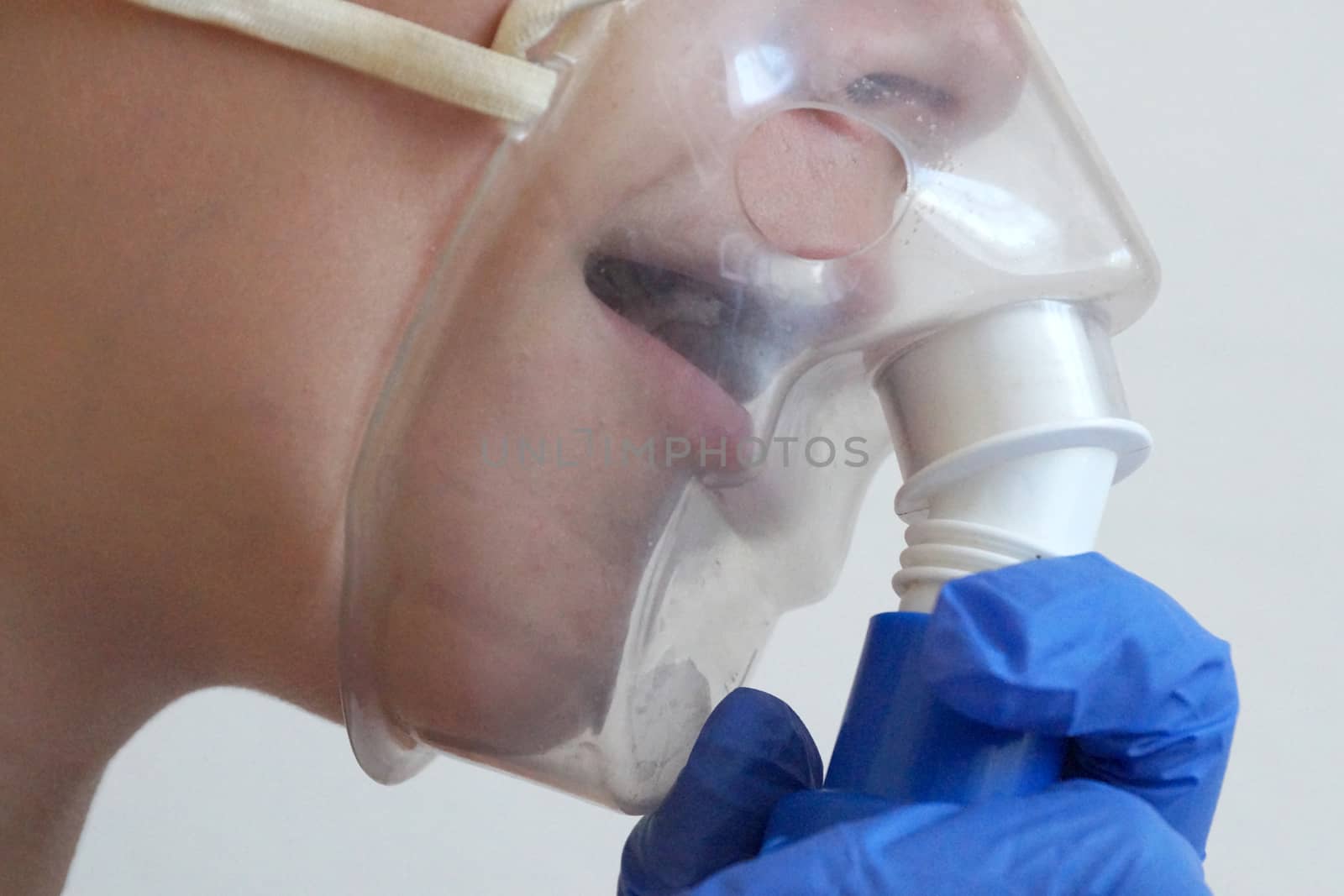 girl breathing through an inhaler, portrait close up