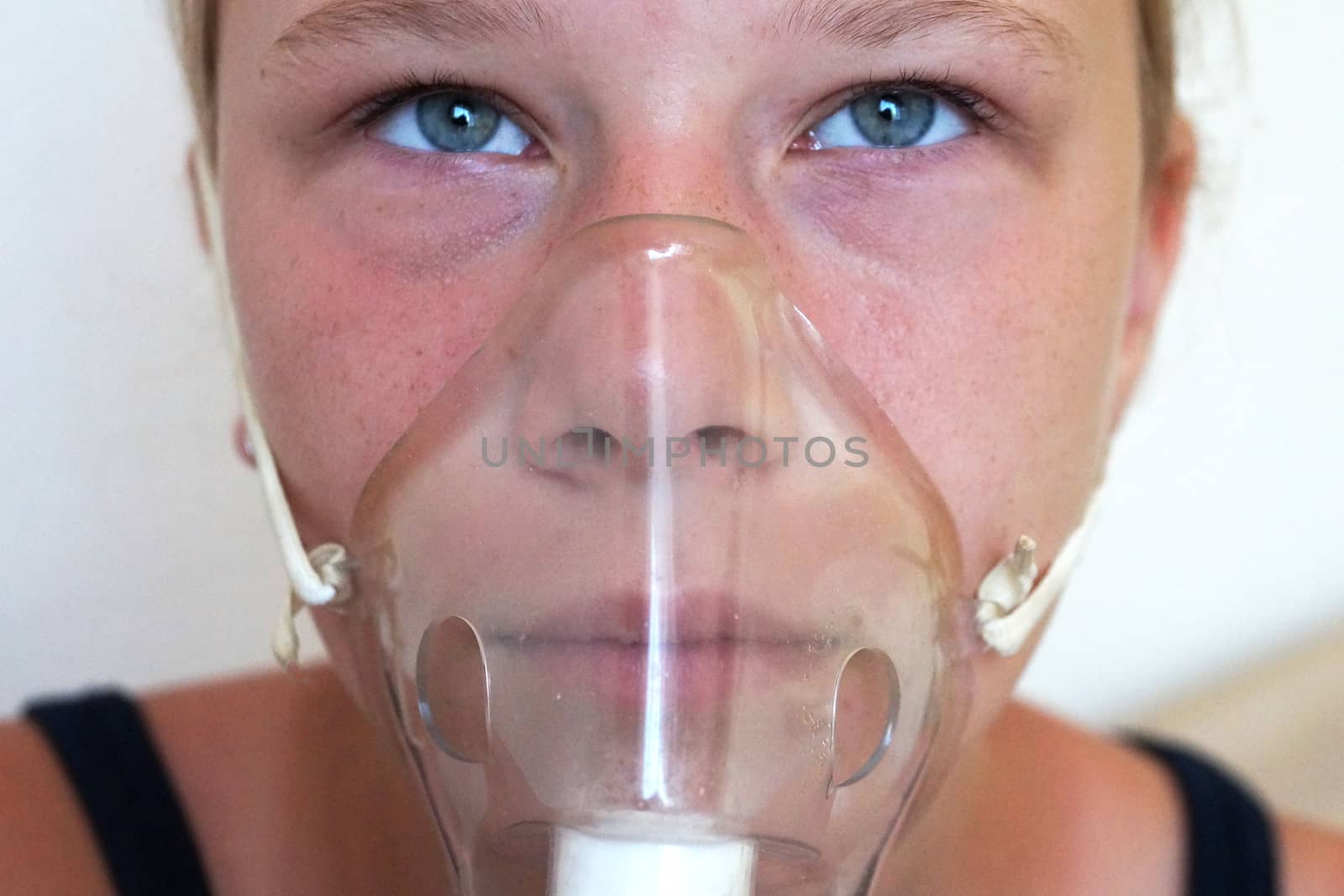 girl breathing through an inhaler, portrait close-up by Annado