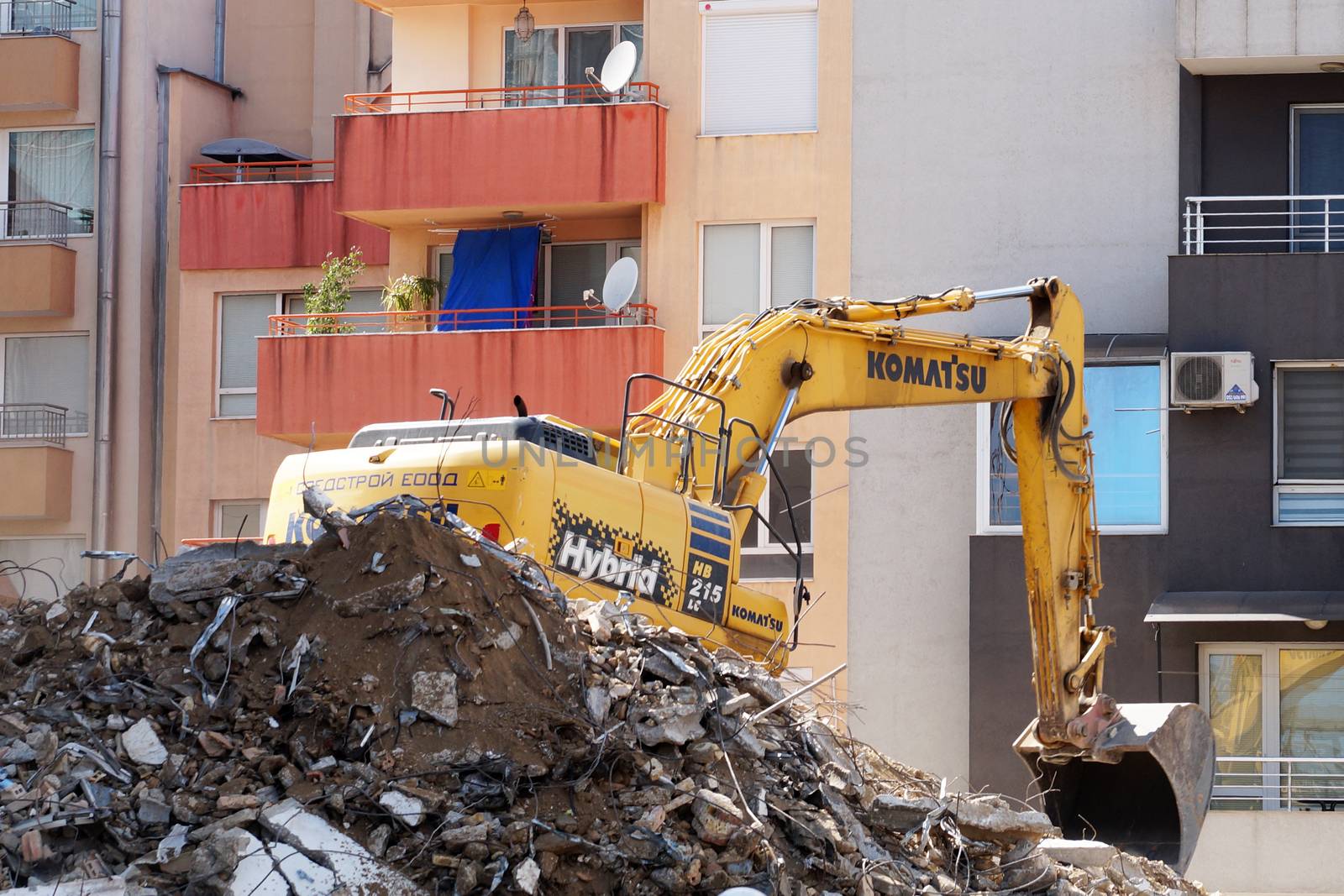 Varna, Bulgaria - August, 04,2020: excavator demolishes a house in a residential area