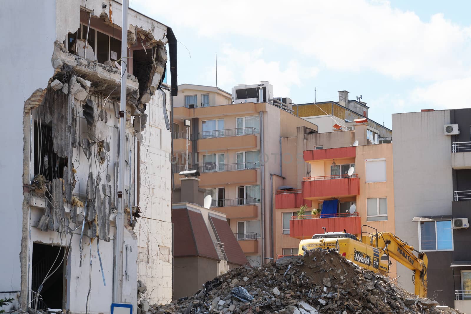 Varna, Bulgaria - August, 04,2020: excavator demolishes a house in a residential area