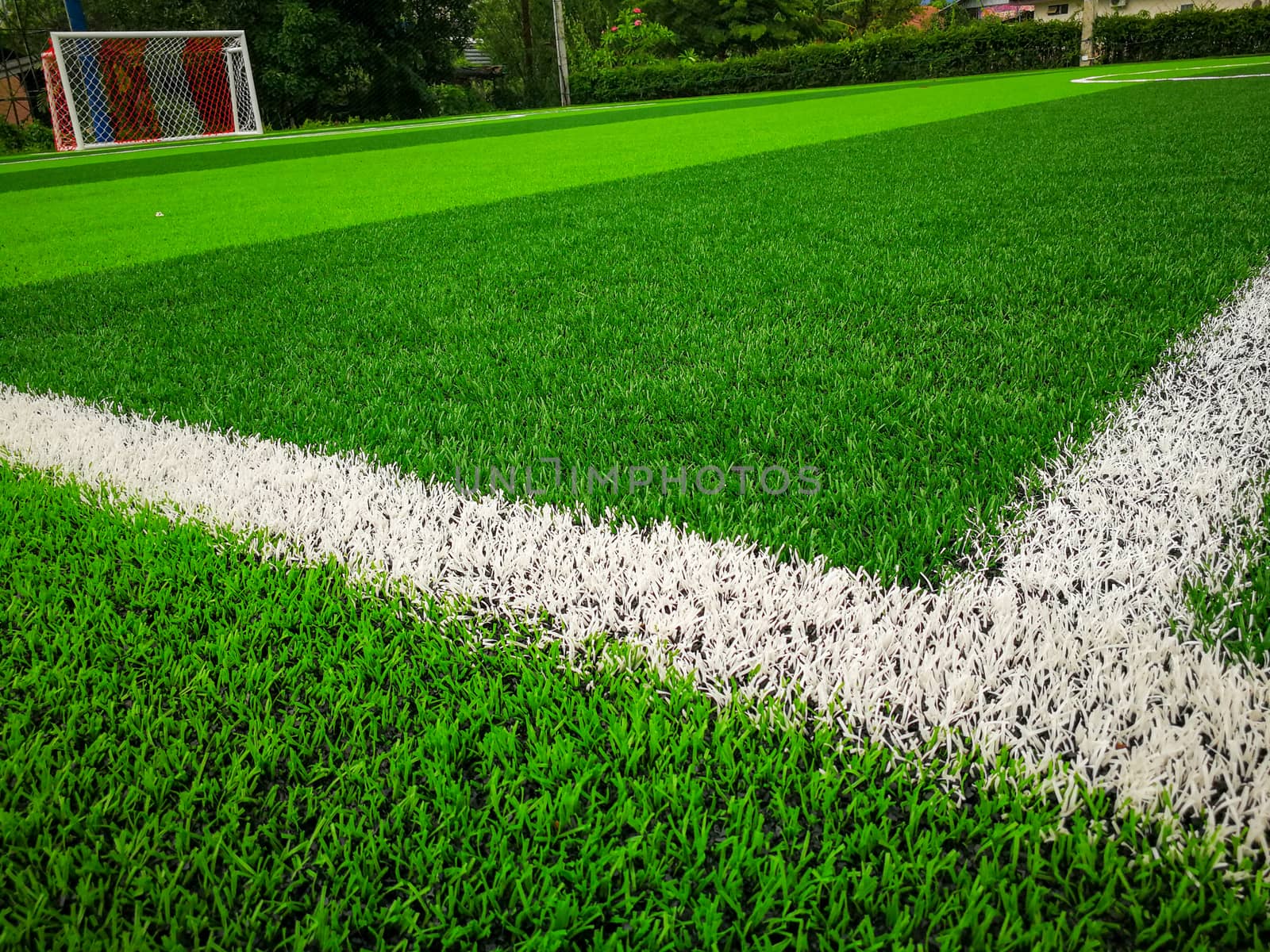 Football field, astro turf surface. Close up of throw in, kick off and corner area. Lushed green football pitch.