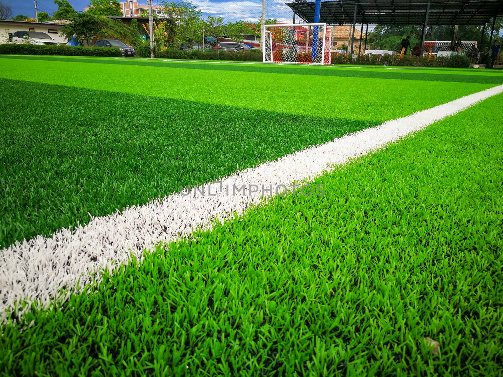 Football field, astro turf surface. Close up of throw in, kick off and corner area. Lushed green football pitch.