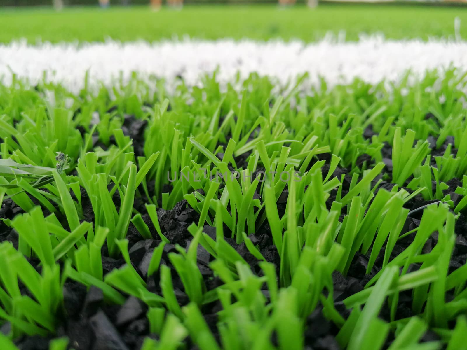 Football field, astro turf surface. Close up of throw in, kick off and corner area. Lushed green football pitch.