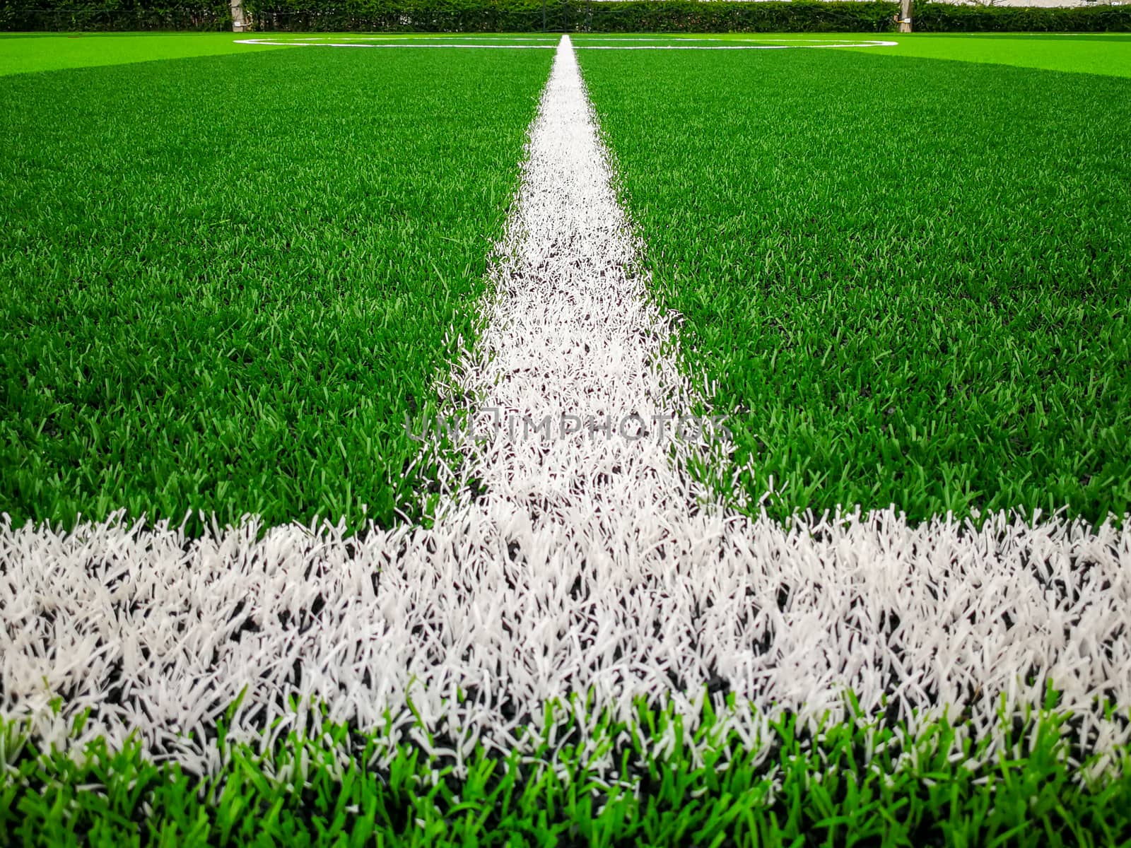 Football field, astro turf surface. Close up of throw in, kick off and corner area. Lushed green football pitch.