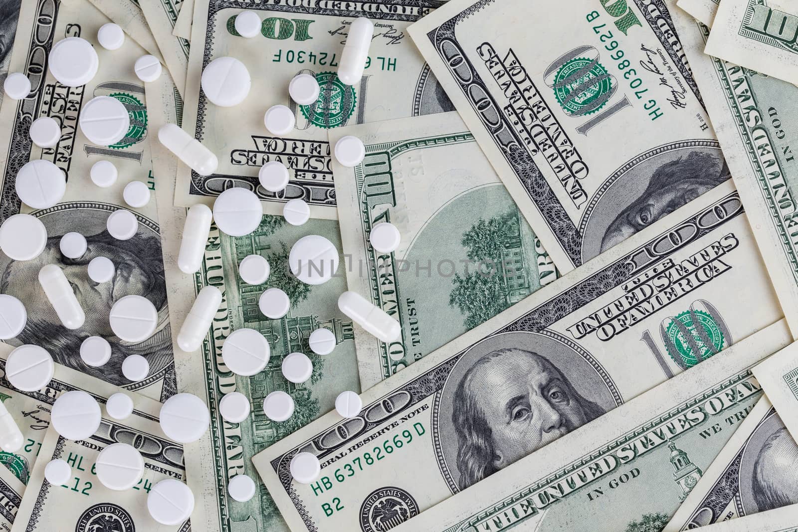 pills flat background, tablets on a us dollar banknotes - top-down view.