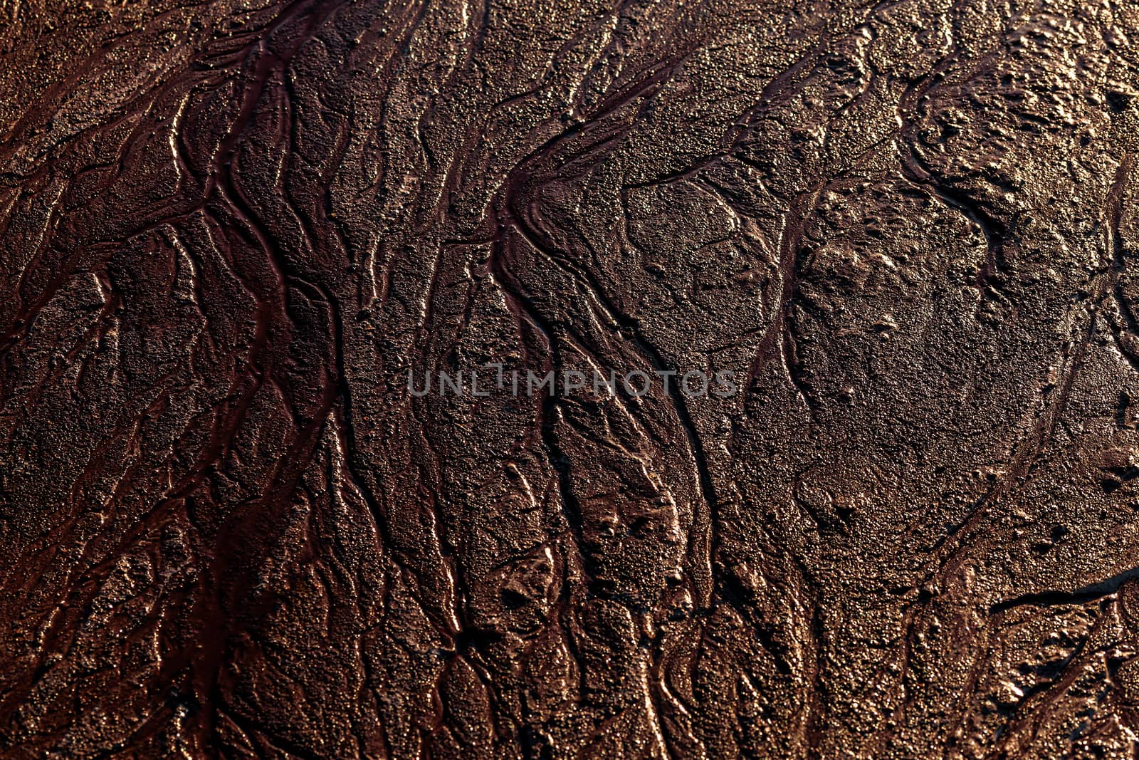 abstract mud background with water washout trails and selective focus.