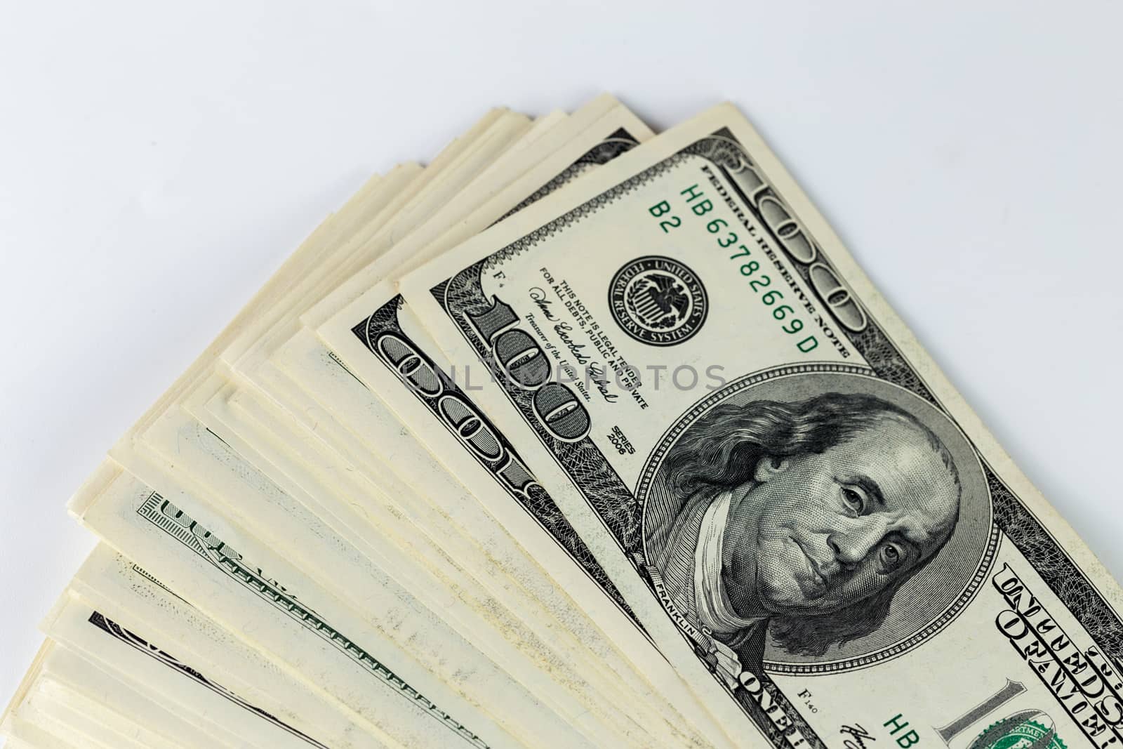 a skewed stack of old us dollar banknotes on white background - close shot.