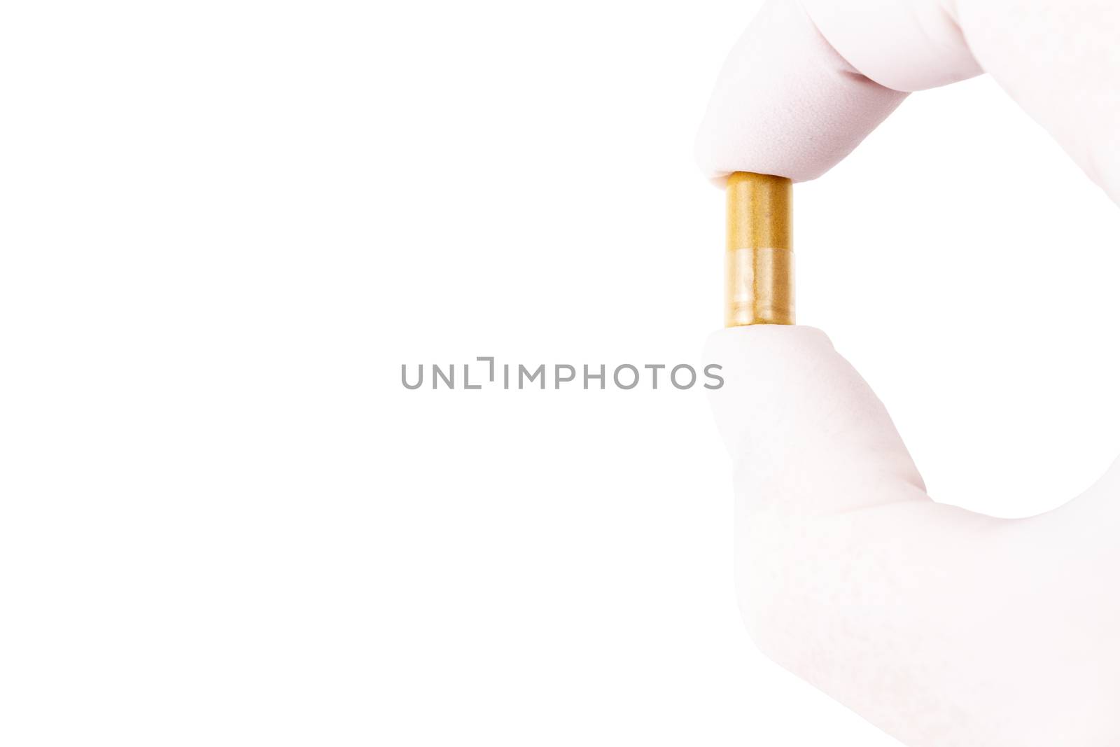hand in medical glove holding organic med capsule isolated on white background closeup.