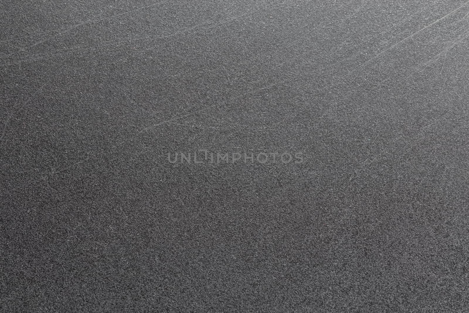 Abstract black scratched suface closeup background with selective focus