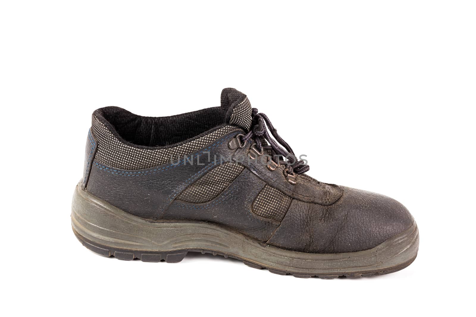 One used blue leather work shoe with fabric incuts isolated on white background.