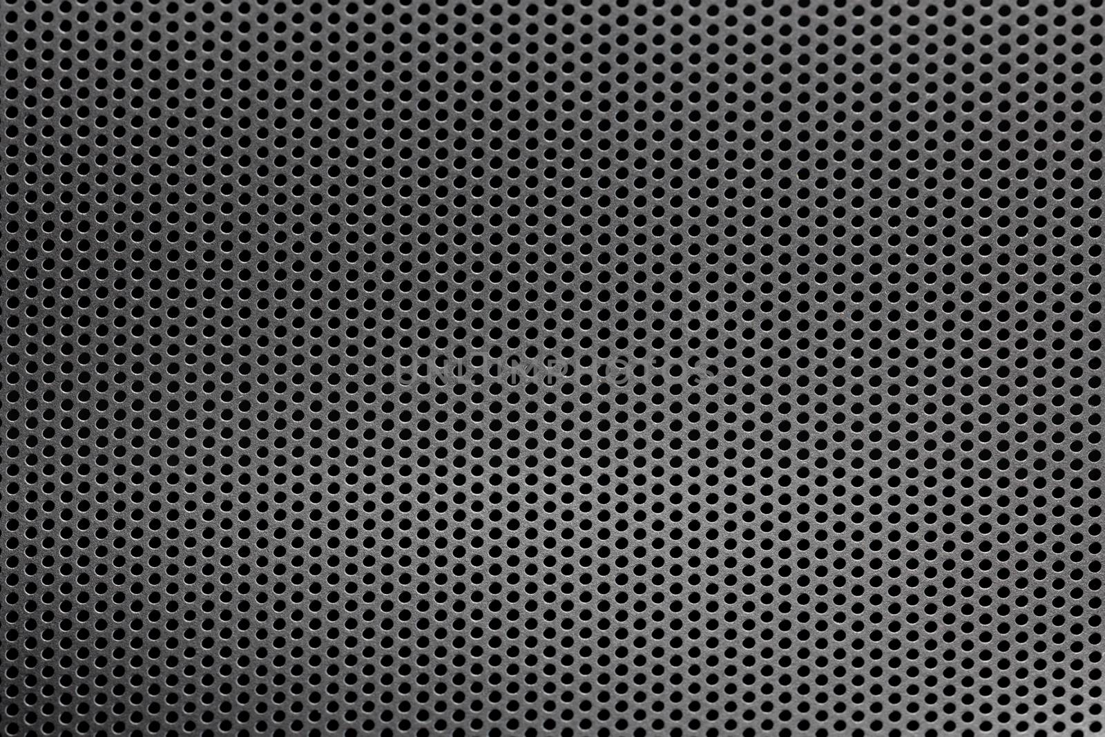Black mesh screen background and texture with round hexagonal holes with selective focus