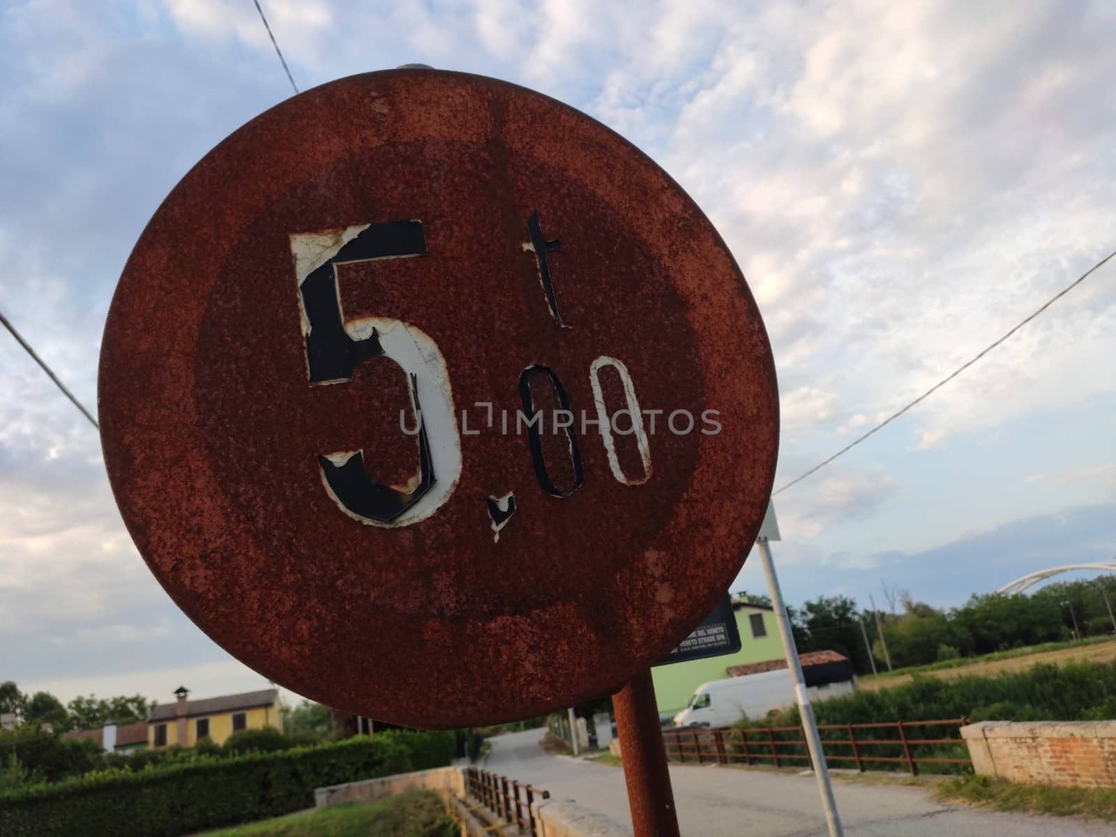 Old and Rusty road sign in a street in Italy