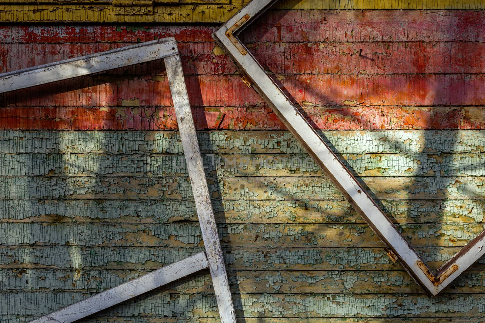 Abstract composition with a frames on old wooden wall with weathered peeling paint