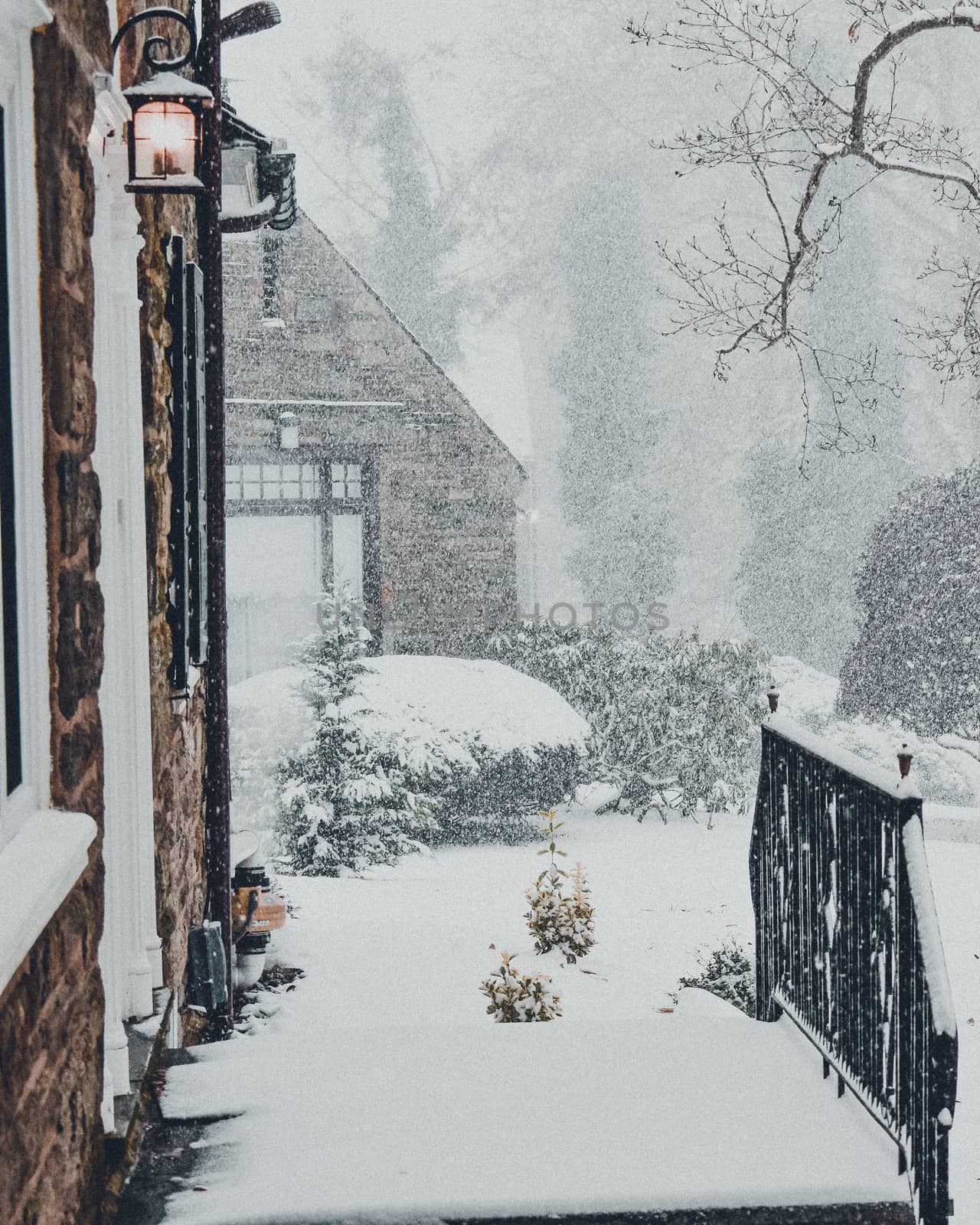 A Snow Covered Entryway to a Large Suburban Home by bju12290