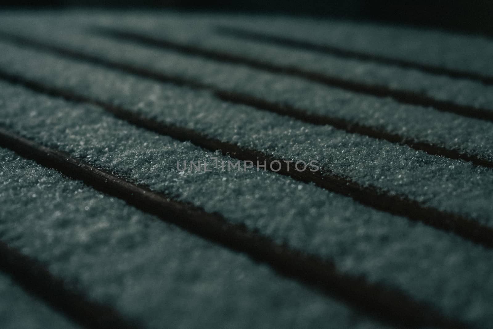 A Close-Up Shot of a Wooden Seat Covered in a Fresh Layer of Snow