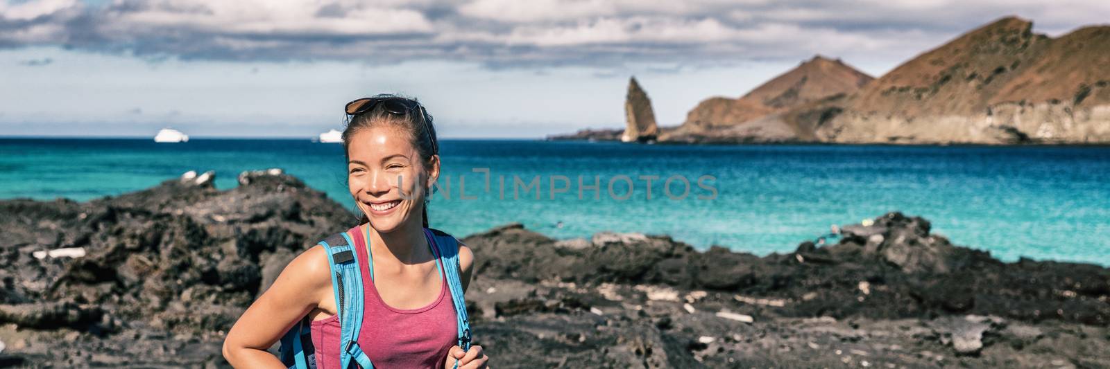 Panoramic banner of Galapagos tourist walking on Santiago Island in Galapagos Islands. Pinnacle Rock and Bartolome Island in background. Famous Galapagos cruise ship tour destination by Maridav