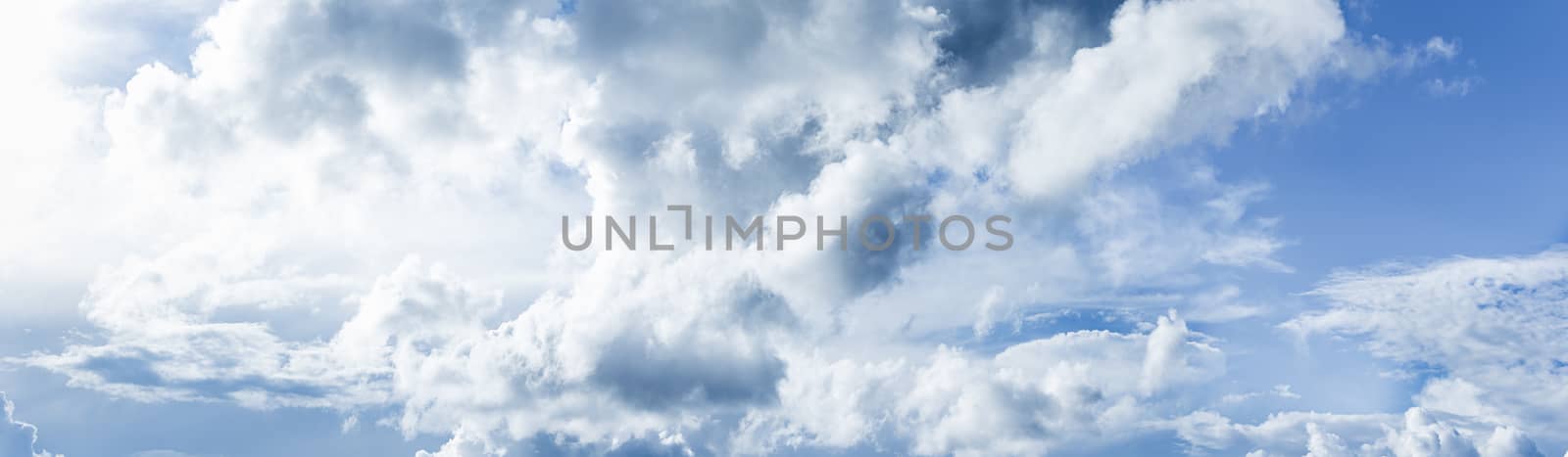 Panoramic white fluffy clouds in the blue sky, Fantastic soft white clouds against blue sky