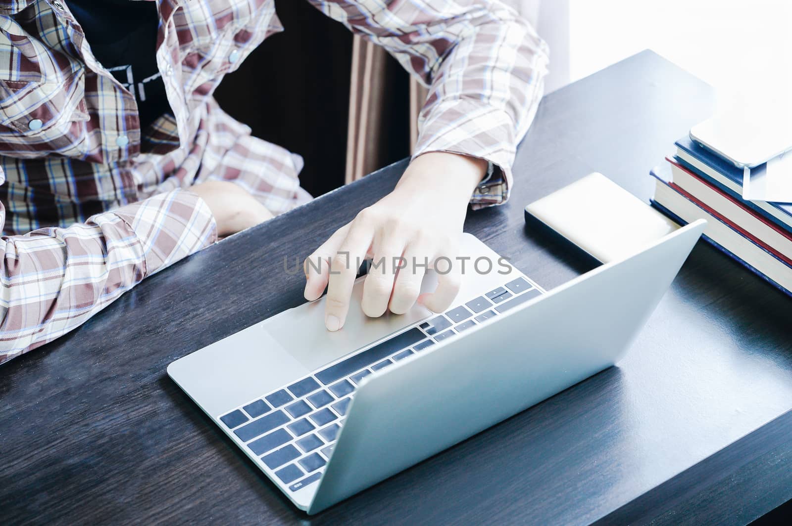 Male hands working with a Laptop computer on the table working at home