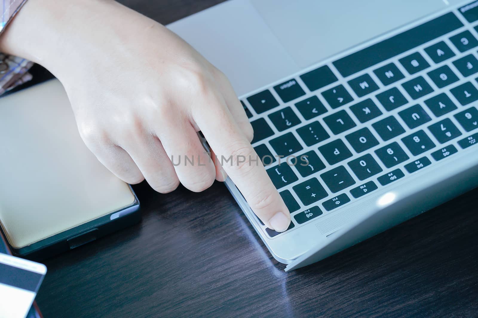 Male hands working with a Laptop computer on the table working at home
