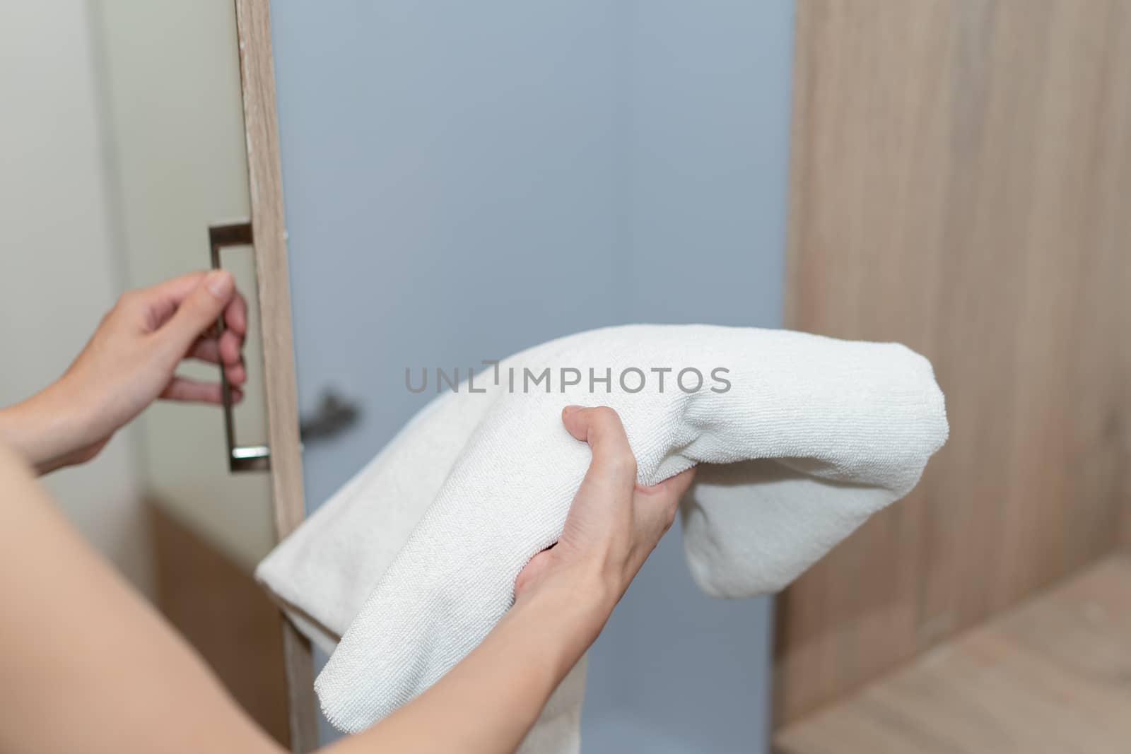 Woman hand open drawer and picking up Towel.
