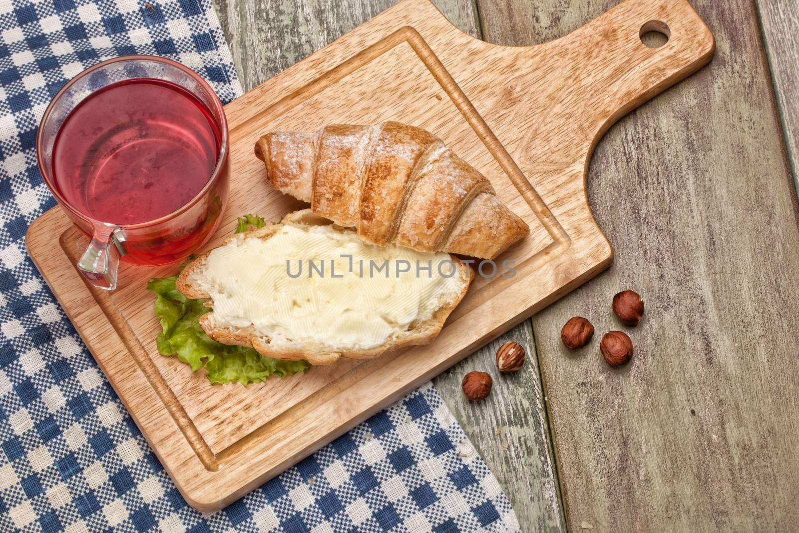 Cup and and pastry with chocolate on a wooden desk