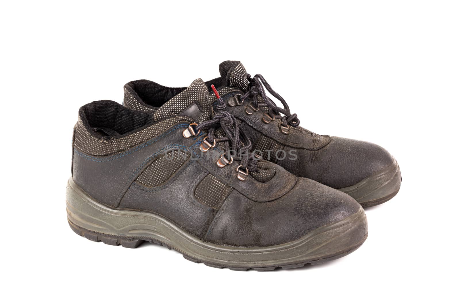 a pair of used blue leather work shoes with fabric incuts isolated on white background.