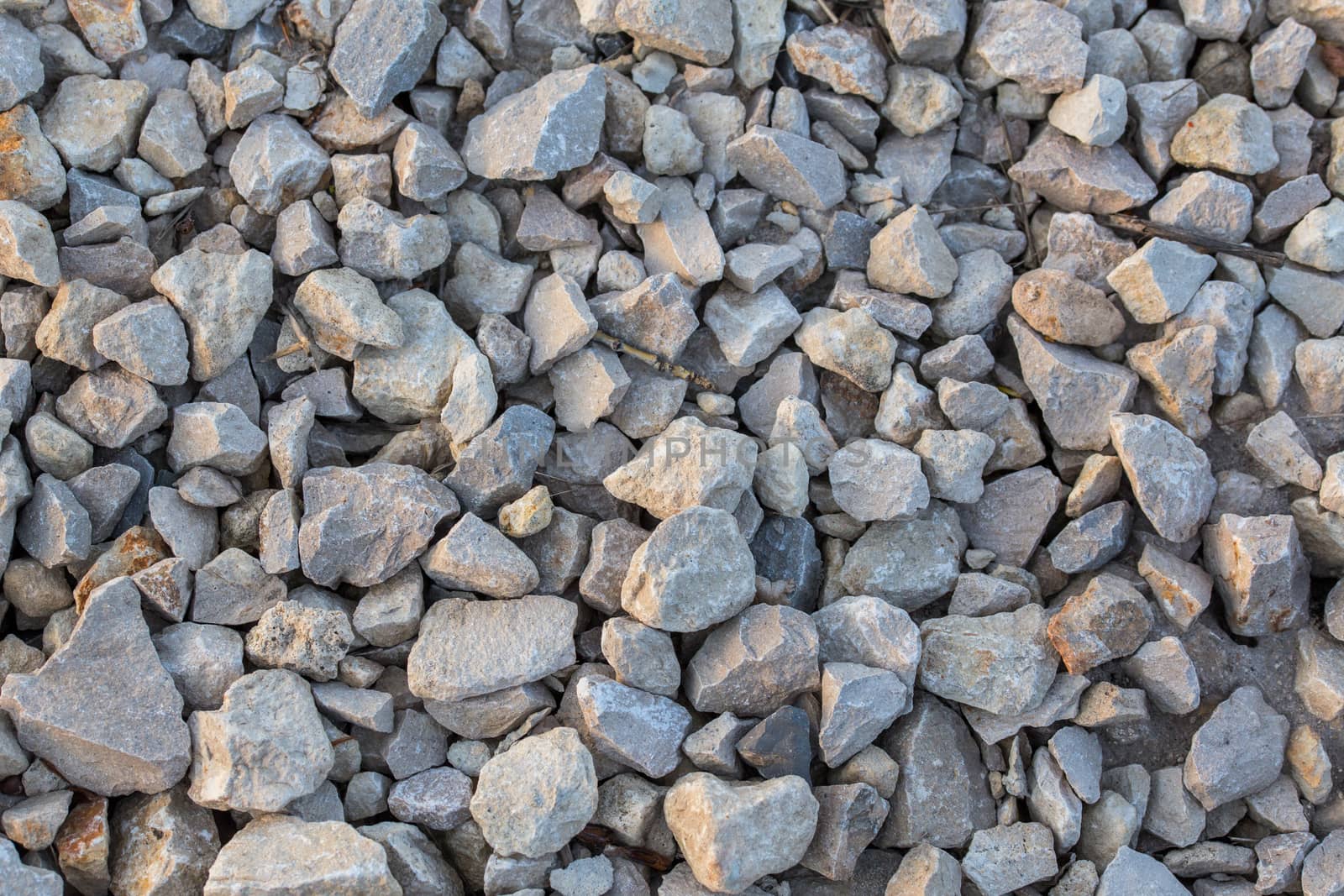 flat macadam closeup background with pair of small dry sticks
