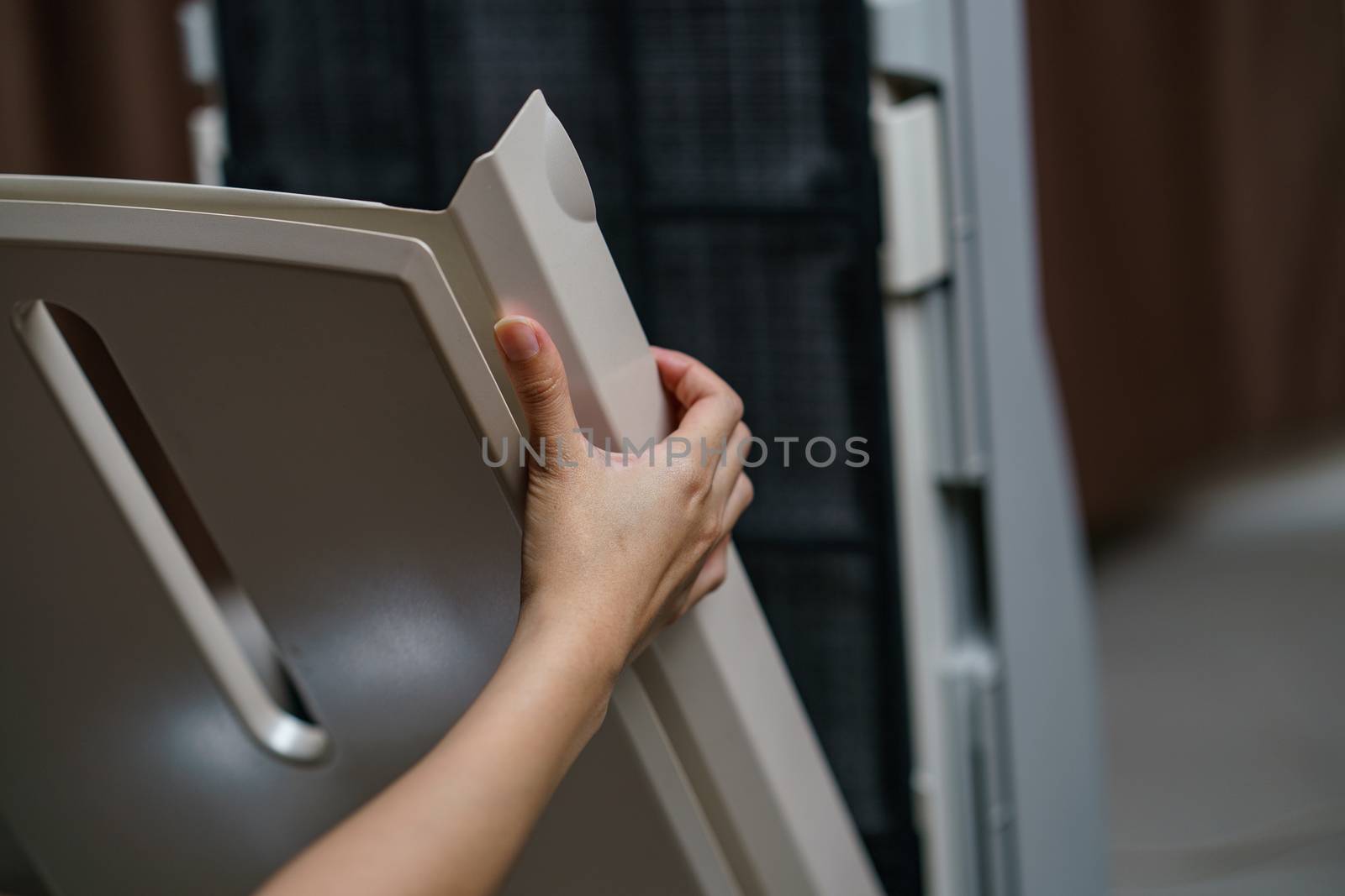 Woman hand open air purifier for clean dirty air purifier HEPA filter.